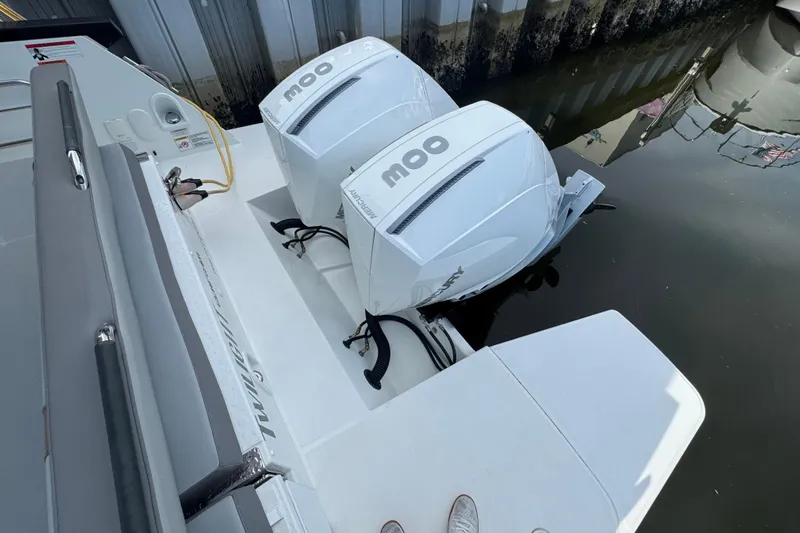  Yacht Photos Pics 2022 Beneteau Gran Turismo 32 with twin Mercury outboard engines docked by the water.