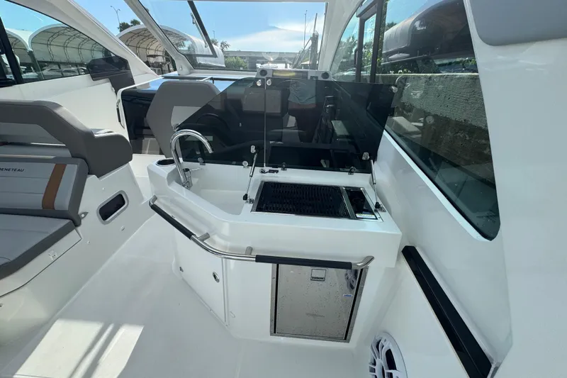  Yacht Photos Pics Interior of 2022 Beneteau Gran Turismo 32 yacht with kitchenette and seating area.