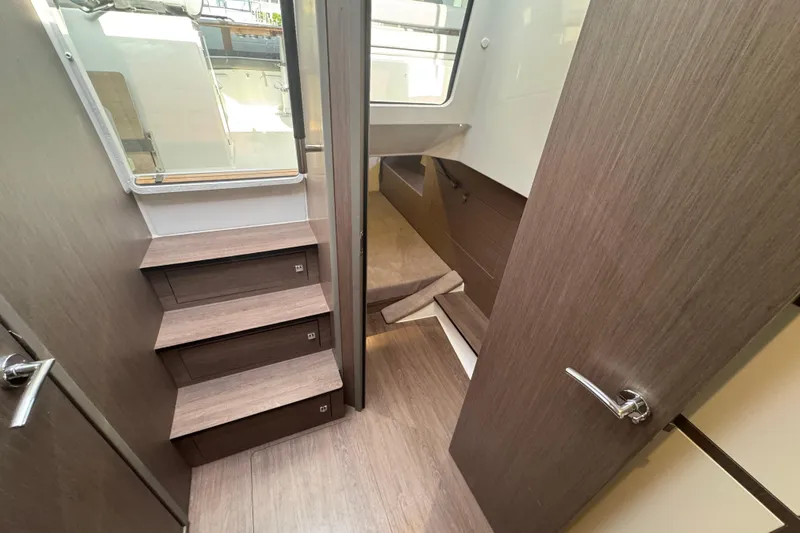  Yacht Photos Pics Interior of 2022 Beneteau Gran Turismo 32 yacht, featuring wooden stairs and modern design.