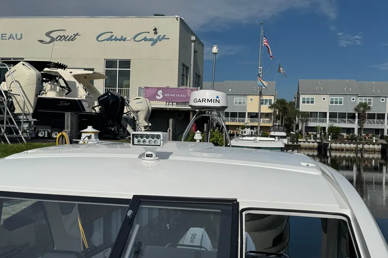  Yacht Photos Pics 2022 Beneteau Gran Turismo 32 at marina with Garmin equipment, Scout and Chris-Craft boats visible.