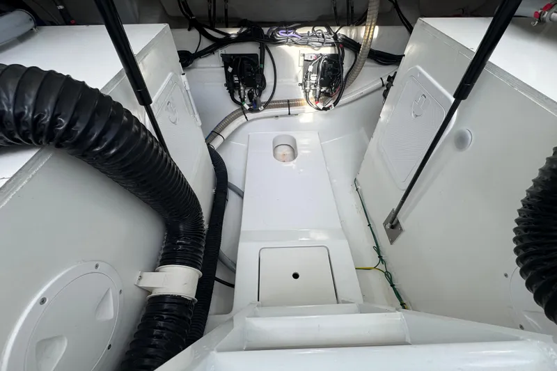  Yacht Photos Pics Engine compartment of 2022 Beneteau Gran Turismo 32 with visible wiring and ventilation hoses.