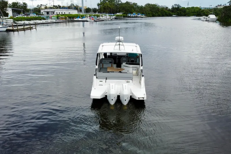  Yacht Photos Pics 2022 Beneteau Gran Turismo 32 yacht on calm water, rear view.