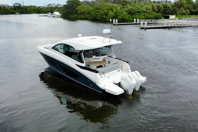  Yacht Photos Pics 2022 Beneteau Gran Turismo 32 yacht on a serene river, showcasing sleek design and powerful engines.