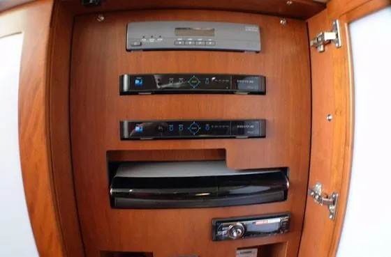  Yacht Photos Pics 2012 Sea Ray 540 Sundancer entertainment system with wooden cabinet and electronic components.
