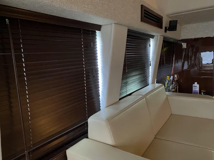 Cheri Pie Yacht Photos Pics Luxurious interior of 2008 Sea Ray 47 Sedan Bridge with leather seating and wooden blinds.