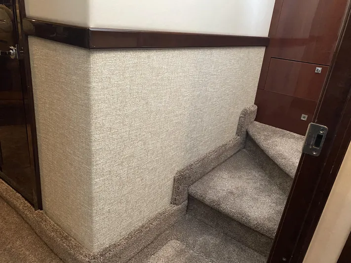 Cheri Pie Yacht Photos Pics Interior stairs of 2008 Sea Ray 47 Sedan Bridge yacht, featuring carpeted steps and wooden accents.