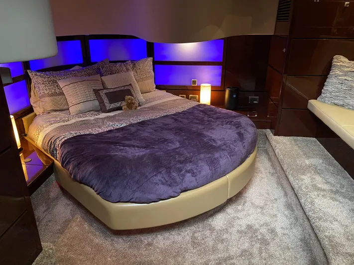 Cheri Pie Yacht Photos Pics Luxurious bedroom interior of 2008 Sea Ray 47 Sedan Bridge yacht with plush bedding and ambient lighting.