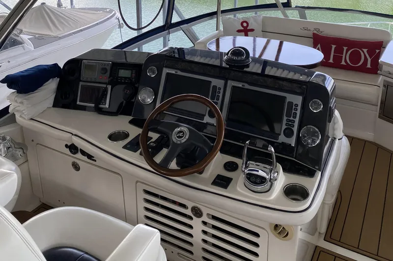 Cheri Pie Yacht Photos Pics 2008 Sea Ray 47 Sedan Bridge helm with advanced navigation controls and wooden steering wheel.