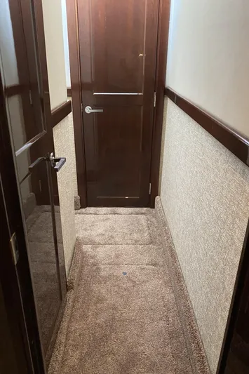 Cheri Pie Yacht Photos Pics Hallway inside 2008 Sea Ray 47 Sedan Bridge yacht with carpet and wooden door.