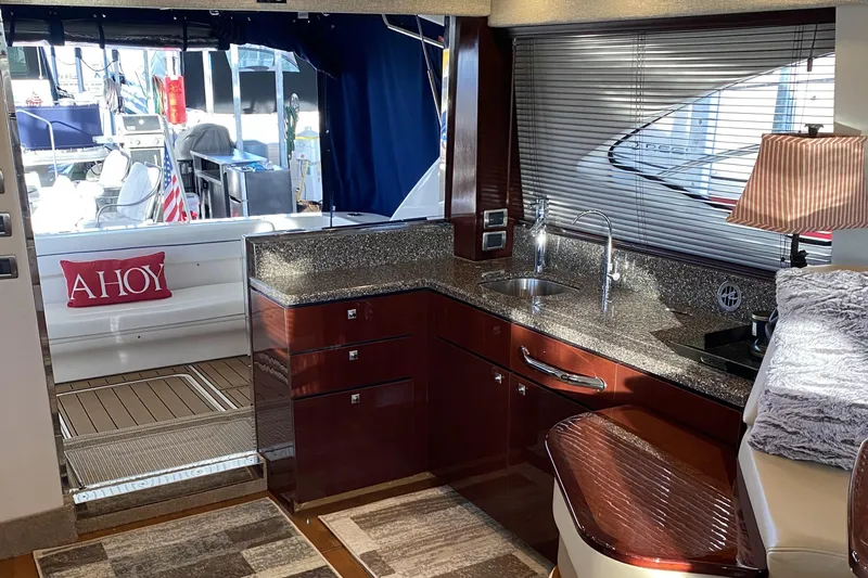 Cheri Pie Yacht Photos Pics Interior of 2008 Sea Ray 47 Sedan Bridge yacht with modern kitchen and outdoor view.