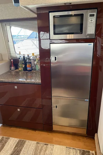 Cheri Pie Yacht Photos Pics Galley kitchen in 2008 Sea Ray 47 Sedan Bridge with microwave and stainless steel fridge.