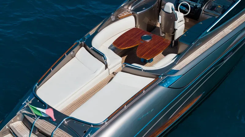 Frida Yacht Photos Pics 2007 Riva Rivarama luxury yacht with elegant seating and wooden table on blue water.