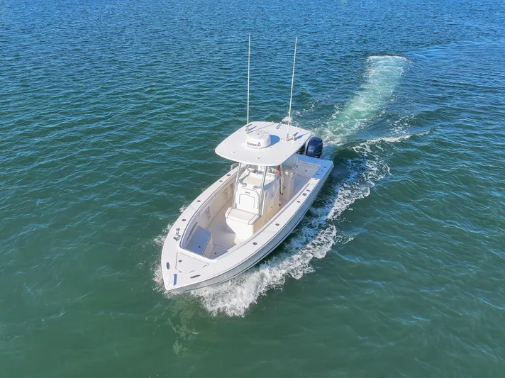  Yacht Photos Pics 2018 Jupiter 26 FS boat cruising on open water, aerial view.