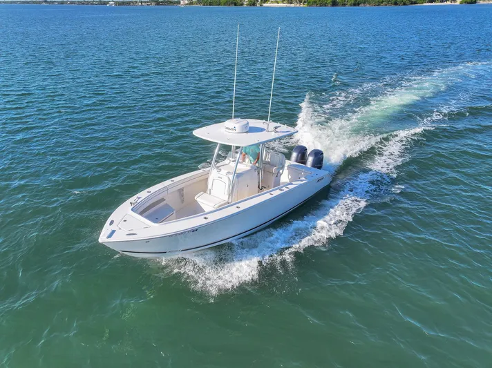  Yacht Photos Pics 2018 Jupiter 26 FS boat cruising on open water, showcasing sleek design and powerful engines.