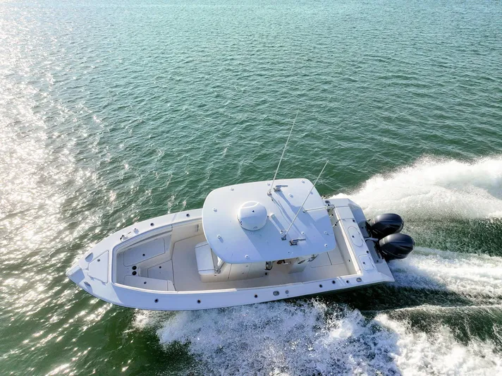  Yacht Photos Pics Aerial view of 2018 Jupiter 26 FS boat cruising on open water.