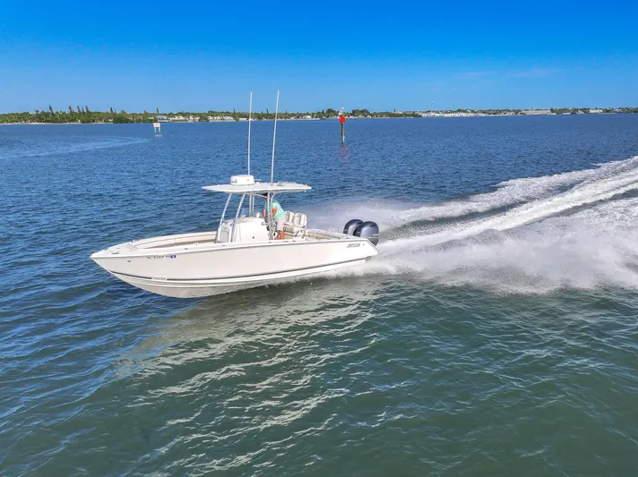  Yacht Photos Pics 2018 Jupiter 26 FS boat cruising on open water under clear blue sky.