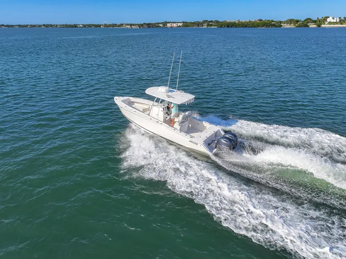  Yacht Photos Pics 2018 Jupiter 26 FS boat cruising on open water, creating a wake.