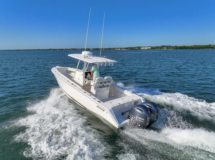  Yacht Photos Pics 2018 Jupiter 26 FS boat cruising on open water with twin engines.