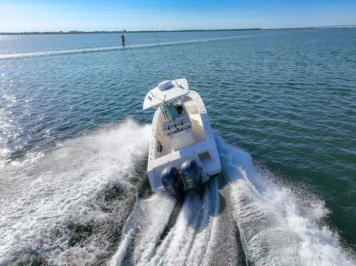  Yacht Photos Pics 2018 Jupiter 26 FS boat cruising on open water, creating a dynamic wake.