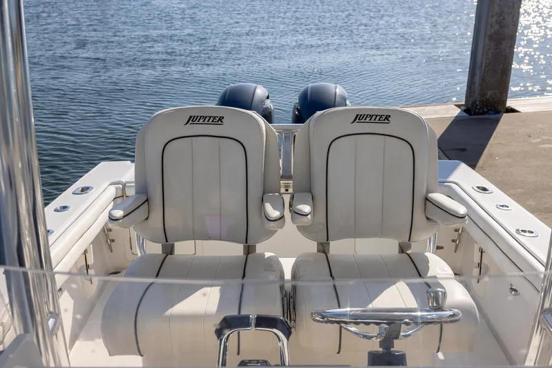  Yacht Photos Pics 2018 Jupiter 26 FS boat with dual seats, docked by the water.