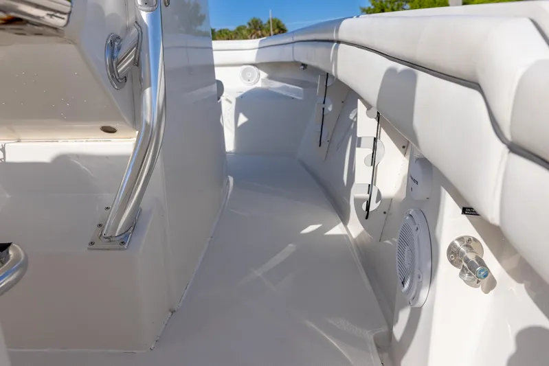  Yacht Photos Pics Interior view of a 2018 Jupiter 26 FS boat, featuring sleek white seating and stainless steel fixtures.