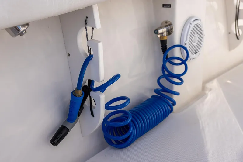  Yacht Photos Pics Blue coiled hose and nozzle on 2018 Jupiter 26 FS boat deck.
