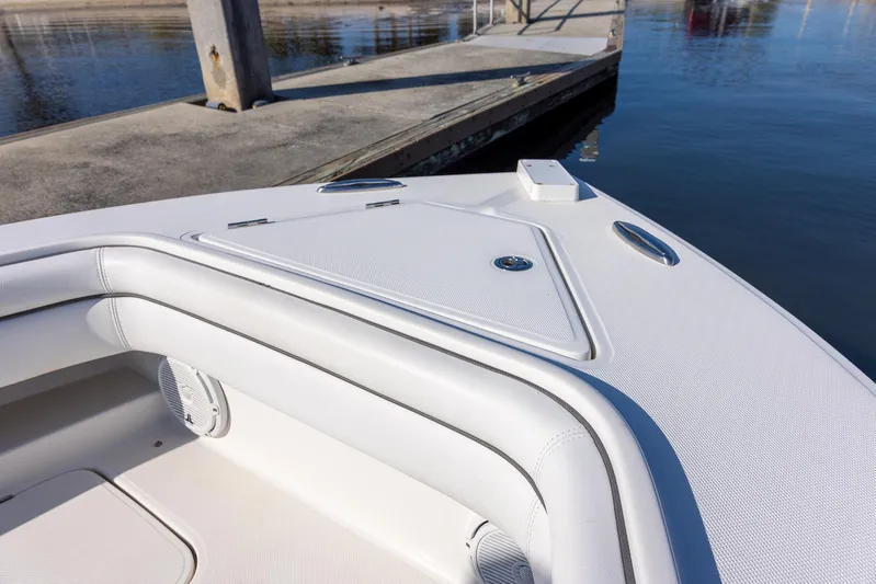  Yacht Photos Pics Bow of 2018 Jupiter 26 FS boat docked by calm water.