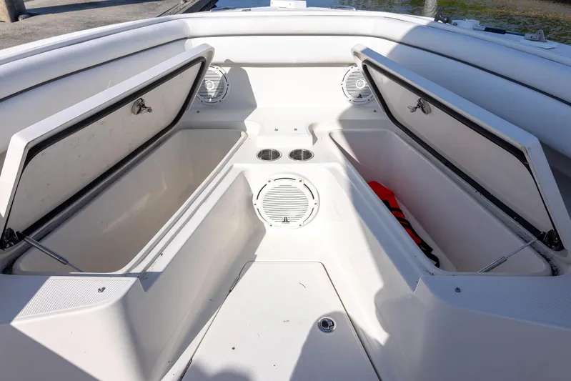  Yacht Photos Pics 2018 Jupiter 26 FS boat interior with open storage compartments and cup holders.