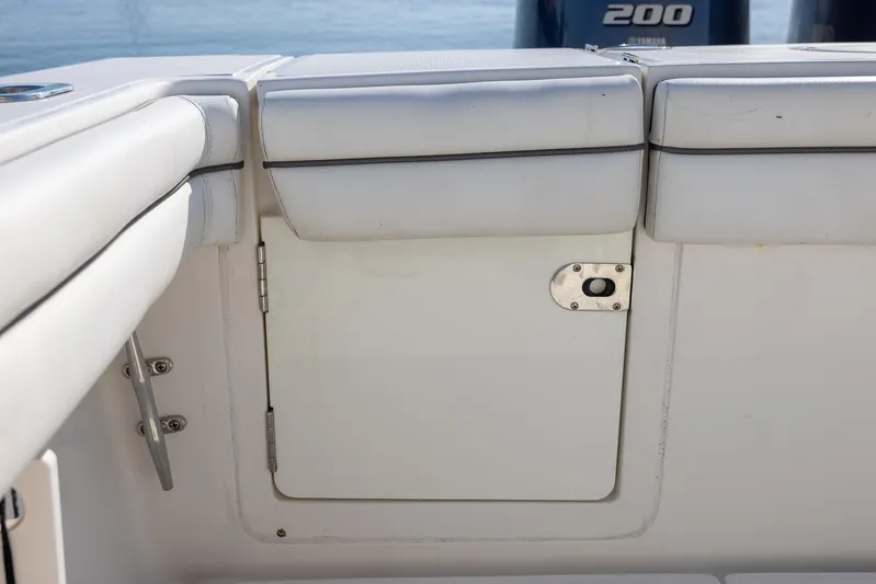  Yacht Photos Pics 2018 Jupiter 26 FS boat interior with white cushioned seating and storage compartment.