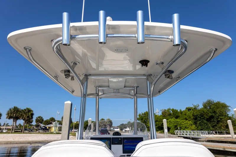  Yacht Photos Pics 2018 Jupiter 26 FS boat with T-top and rod holders, docked under clear blue sky.