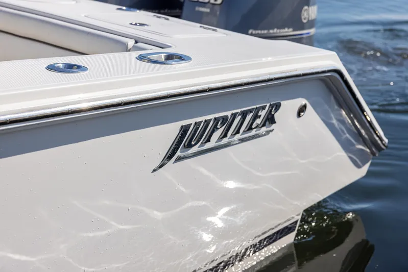  Yacht Photos Pics 2018 Jupiter 26 FS boat, close-up of logo on sleek white hull.