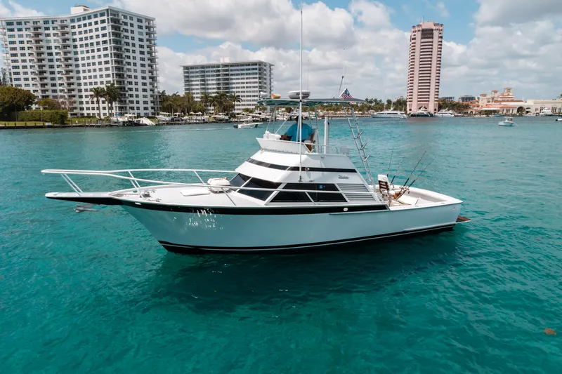 Shannon Yacht Photos Pics 1973 Striker 34 Canyon Runner yacht on turquoise water, cityscape in background.