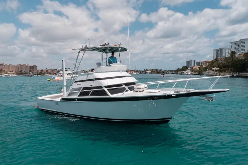 Shannon Yacht Photos Pics 1973 Striker 34 Canyon Runner boat on turquoise water, clear sky, coastal background.