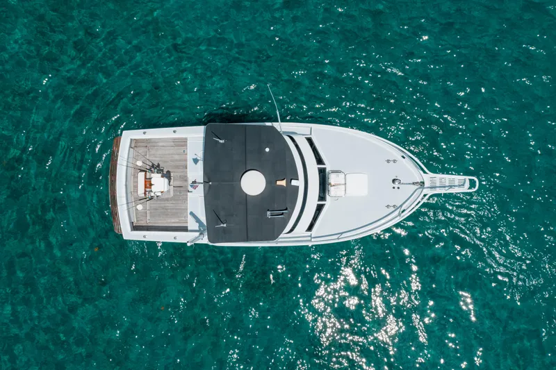 Shannon Yacht Photos Pics Aerial view of 1973 Striker 34 Canyon Runner boat on clear turquoise water.
