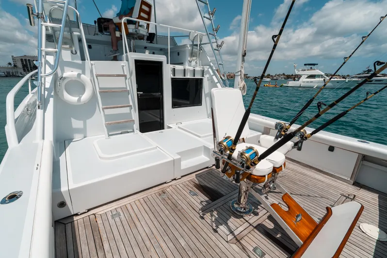 Shannon Yacht Photos Pics 1973 Striker 34 Canyon Runner boat deck with fishing rods, wooden flooring, and ocean view.