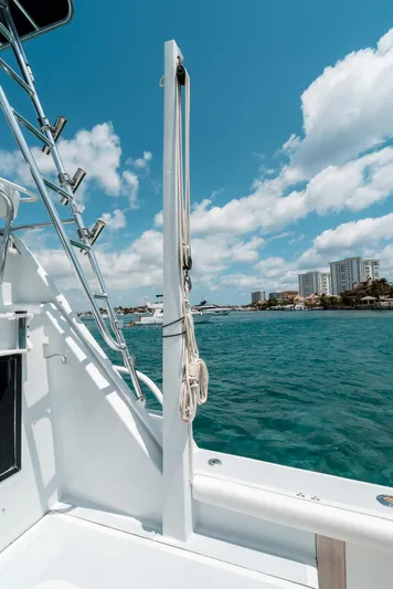 Shannon Yacht Photos Pics 1973 Striker 34 Canyon Runner boat on water, clear sky, coastal buildings in background.