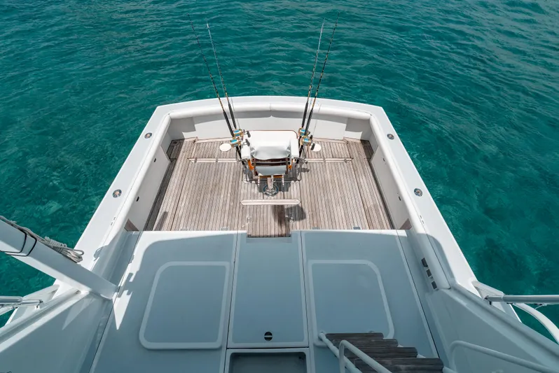 Shannon Yacht Photos Pics 1973 Striker 34 Canyon Runner boat deck with fishing rods, on clear blue water.