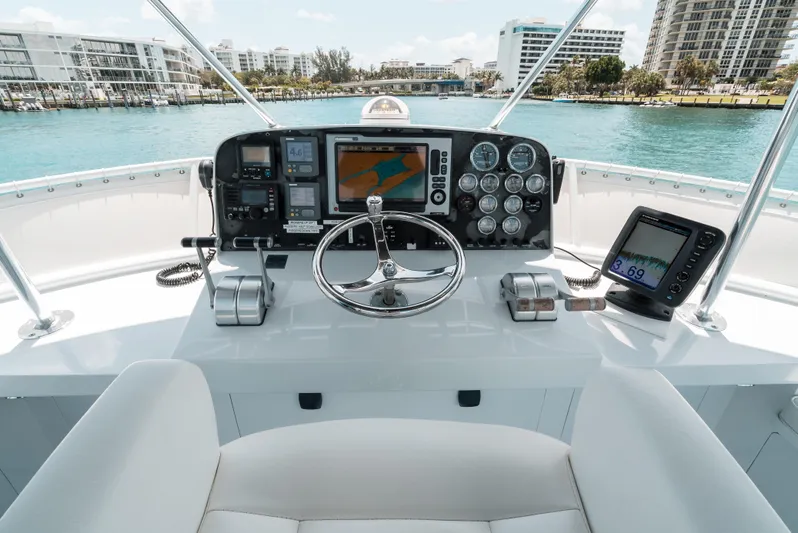 Shannon Yacht Photos Pics Helm of 1973 Striker 34 Canyon Runner with modern navigation equipment, overlooking waterfront buildings.