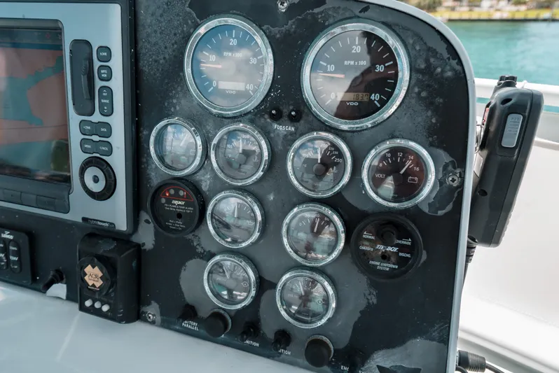 Shannon Yacht Photos Pics Control panel of a 1973 Striker 34 Canyon Runner boat with gauges and navigation equipment.