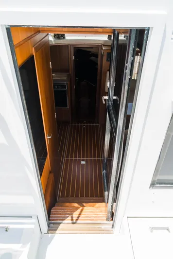 Shannon Yacht Photos Pics Interior view of 1973 Striker 34 Canyon Runner boat, featuring wooden flooring and cabin entrance.