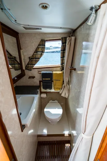 Shannon Yacht Photos Pics 1973 Striker 34 Canyon Runner boat bathroom with sink, toilet, and window view.