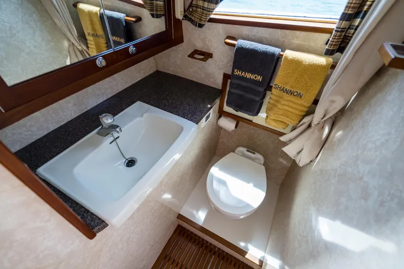 Shannon Yacht Photos Pics 1973 Striker 34 Canyon Runner bathroom with sink, toilet, and towels labeled "Shannon."