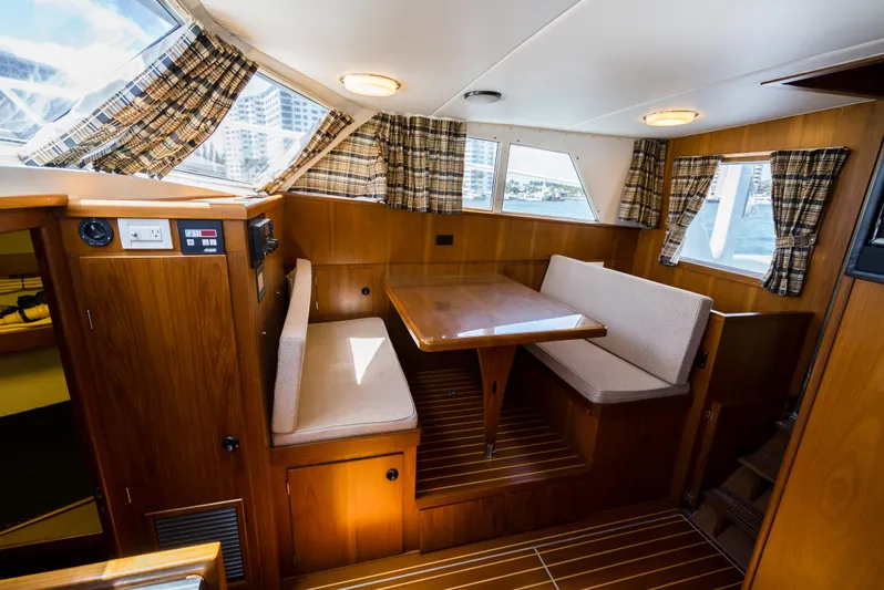 Shannon Yacht Photos Pics Interior of 1973 Striker 34 Canyon Runner with wood paneling and dining area.