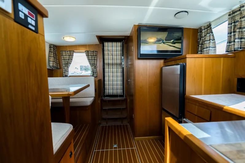 Shannon Yacht Photos Pics Interior of a 1973 Striker 34 Canyon Runner boat with wood paneling and seating area.