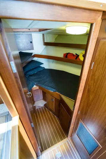 Shannon Yacht Photos Pics 1973 Striker 34 Canyon Runner cabin interior with wooden finish and cozy sleeping area.