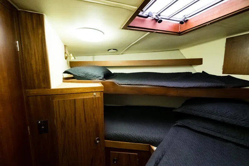 Shannon Yacht Photos Pics 1973 Striker 34 Canyon Runner cabin with wooden interior and bunk beds.