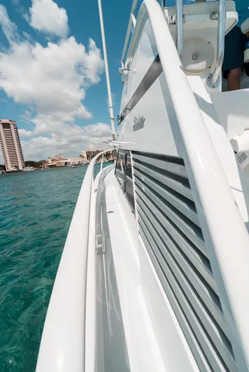 Shannon Yacht Photos Pics 1973 Striker 34 Canyon Runner yacht on clear blue water, sunny day, coastal buildings in background.