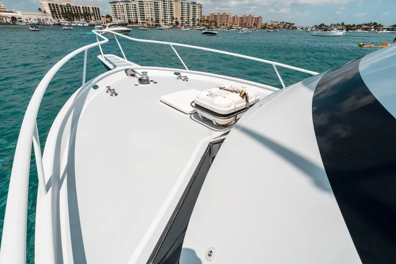 Shannon Yacht Photos Pics 1973 Striker 34 Canyon Runner yacht on clear blue water, with cityscape in background.