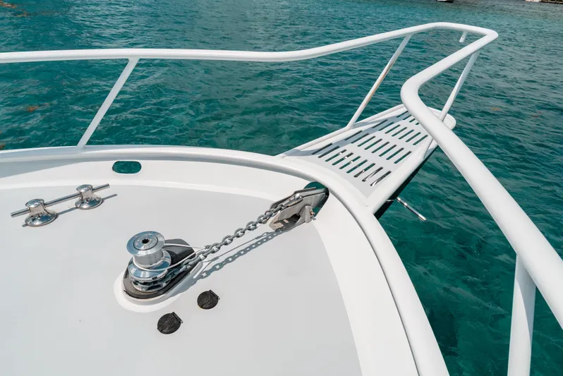 Shannon Yacht Photos Pics Bow of 1973 Striker 34 Canyon Runner boat with anchor chain, in clear blue water.