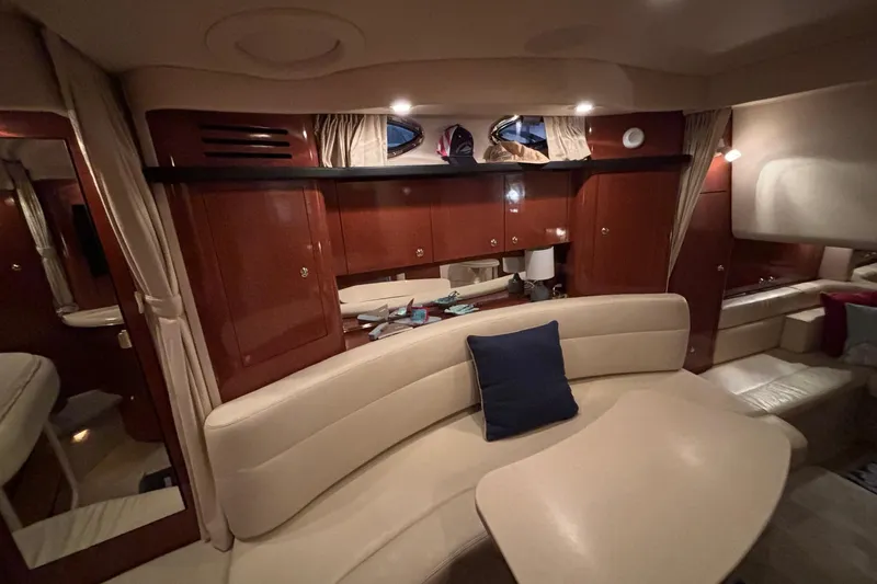 Dulce Vita Yacht Photos Pics Interior of 2003 Sea Ray 340 Sundancer yacht with elegant seating and wooden cabinetry.